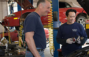 Marc and Technician working on car engine